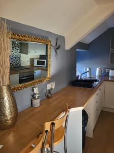 a kitchen with a counter and a mirror on the wall at Three horse shoes in Durham