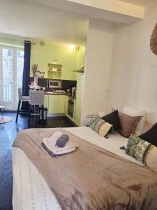 a bedroom with a large bed with towels on it at STUDIO DE L'HORLOGE in Dinan