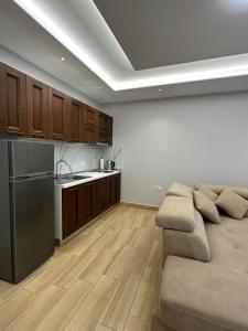 a living room with a couch and a kitchen at Sevians Apartments in Golem