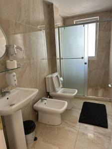 a bathroom with a toilet and a sink and a shower at Sevians Apartments in Golem +19 photos