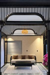 a room with a bed and a couch in a room at Dragon King Hotel Nghệ An in Cửa Lô +24 photos