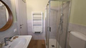 a bathroom with a shower and a sink and a mirror at Casa Noa in Crema