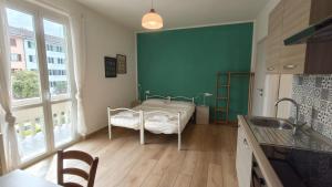 a kitchen with a bed in the corner of a room at Casa Noa in Crema +9 photos