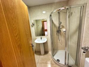 a bathroom with a shower and a sink at Hostal Fuentes in Labajos