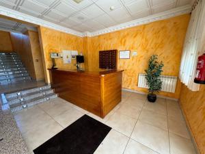 a lobby with a desk and a potted plant at Hostal Fuentes in Labajos