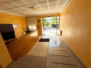 an empty room with a hallway with wooden floors at Hostal Fuentes in Labajos