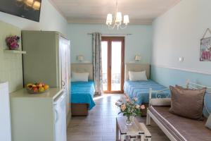 a living room with two beds and a couch at Aravanes in Thrónos