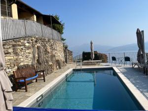 a swimming pool in front of a building at Villa Paradiso in Cannero Riviera