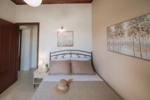 a bedroom with a bed with a hat on it at The Morus House with Private pool in Melidhónion