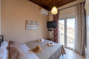 a teddy bear sitting on a bed in a bedroom at The Morus House with Private pool in Melidhónion +51 photos