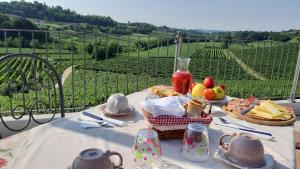 a table with a basket of bread and fruit on it at Enoturismo Le Rampe in Vittorio Veneto +32 photos