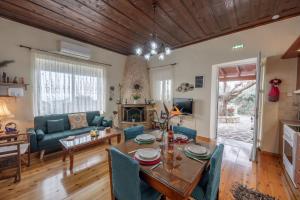 a living room with a table and a couch at The Morus House with Private pool in Melidhónion