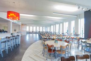 a dining room with tables and chairs and windows at Carleton University – Ottawa in Ottawa