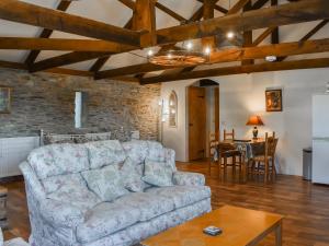 a living room with a couch and a table at The Hayloft - Uk50027 in Liskeard