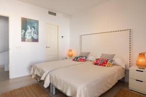 a bedroom with a bed with two pillows on it at Villa Blanca Santa Eulalia in Santa Eularia des Riu