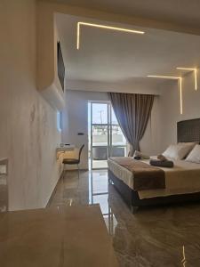 a bedroom with a bed and a desk in it at Casa Blue Sarantis in Faliraki +150 photos