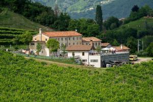 a small village on a hill with a building at Enoturismo Le Rampe in Vittorio Veneto