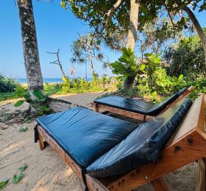 two beds sitting on a table on the beach at Revival Beach Resort in Hikkaduwa