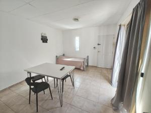 a small room with a table and a bed at Depto guemez1 in General Roca