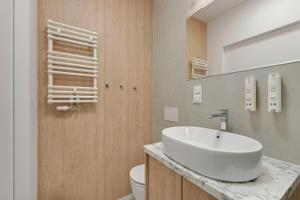 a bathroom with a sink and a toilet at GRANO FLATS Sobieszewo - Villa Neptun in Sobieszewo +26 photos
