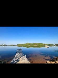 a view of a dock on a lake at Дом на берегу озера Саймаа in Ruokolahti +3 photos