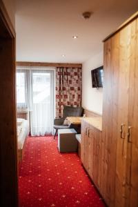 a hotel room with a bed and a living room at Pension Singer in Innsbruck