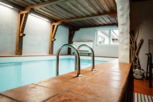 a swimming pool with two faucets in a house at Pension Singer in Innsbruck