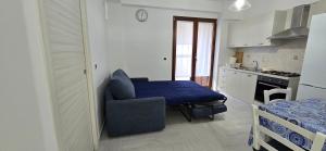 a kitchen with a table and a chair in a room at La Casetta Nuova struttura in Palinuro +3 photos