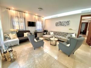 a living room with couches and chairs and a couch at The Amathountas Residence in Pyrgos