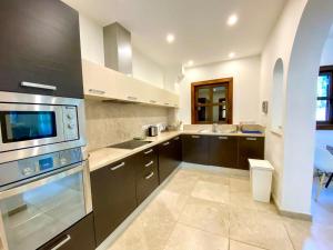 a kitchen with a sink and a stove top oven at The Amathountas Residence in Pyrgos