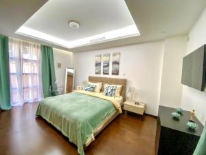 a bedroom with a bed with a green bedspread at The Amathountas Residence in Pyrgos