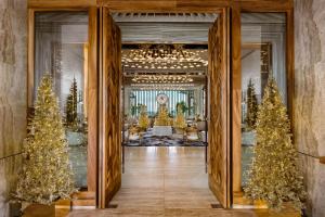 a hallway with christmas trees in a building at Waldorf Astoria Riviera Maya in Cancún