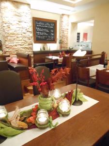 a tray of food on a table in a restaurant at Hotel Pfeffermühle in Borchen