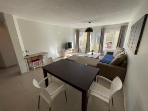 a living room with a table and a couch at Central Apartment at Bismarck5 in Swakopmund