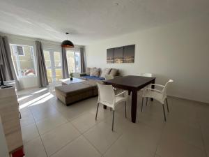 a living room with a table and chairs and a couch at Central Apartment at Bismarck5 in Swakopmund