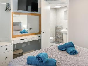 a bedroom with a bed with blue towels on it at Rose - Uk49363 in Bridlington +3 photos