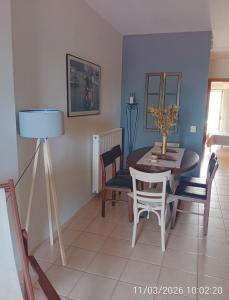 a dining room with a table and chairs at Στης Χαράς in Porto Heli