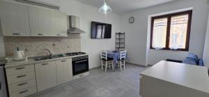 a kitchen with a sink and a stove top oven at La Casetta Mare in Palinuro