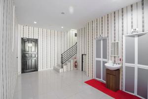 a bathroom with a sink and a staircase at RedDoorz @ Baloi Batam in Batam Center