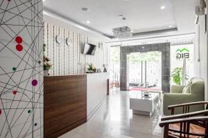 a living room with a couch and a tv in a room at RedDoorz @ Baloi Batam in Batam Center