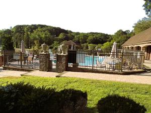 a black fence with a pool in a yard at Chalet Inn & Suites in Centerport