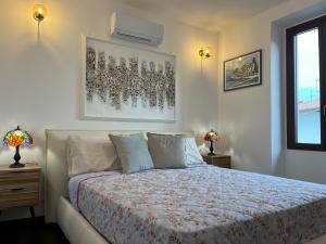 a bedroom with a bed and a air conditioner on the wall at Menaggio Lake Como Elegance in Menaggio