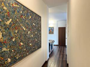 a large painting hanging on a wall in a room at Menaggio Lake Como Elegance in Menaggio
