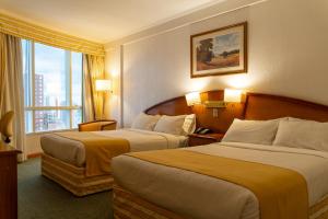 a hotel room with two beds and a window at InterTower Hotel in Santa Fe
