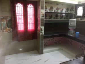 a bathroom with a shower with a red window at Jacobs Cottage KG-F2 in Thiruchendur