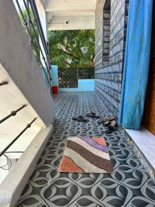 a hallway with a rug on the floor at Jacobs Cottage KG-F2 in Thiruchendur