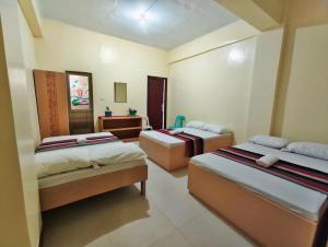 a room with three beds and a sink in it at Best Sagada Lodge within City Proper! in Sagada