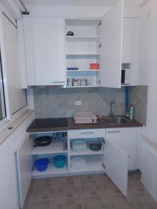 a kitchen with white cabinets and a sink at Pansion Ivanka Barac in Međugorje
