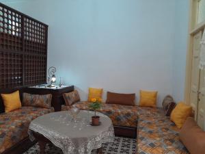 a living room with a couch and a table at dar rachid in Fez