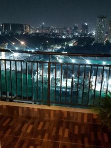 a balcony with a view of the city at night at MaEra's Den in Hinjewadi
